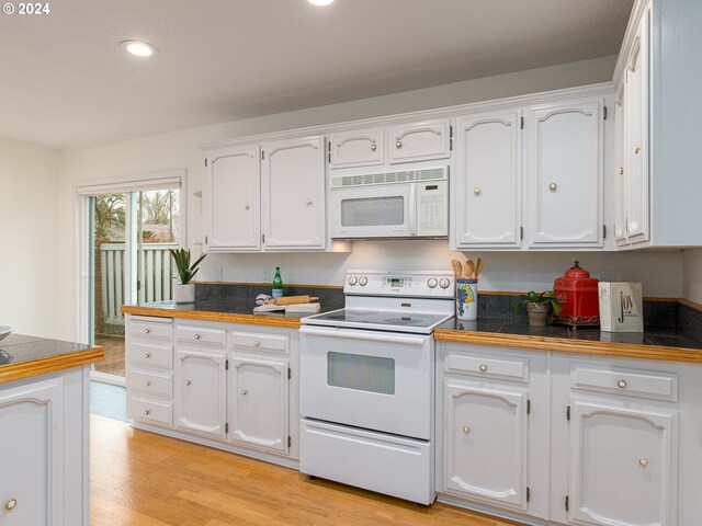 kitchen with white cabinetry, light hardwood / wood-style floors, and white appliances