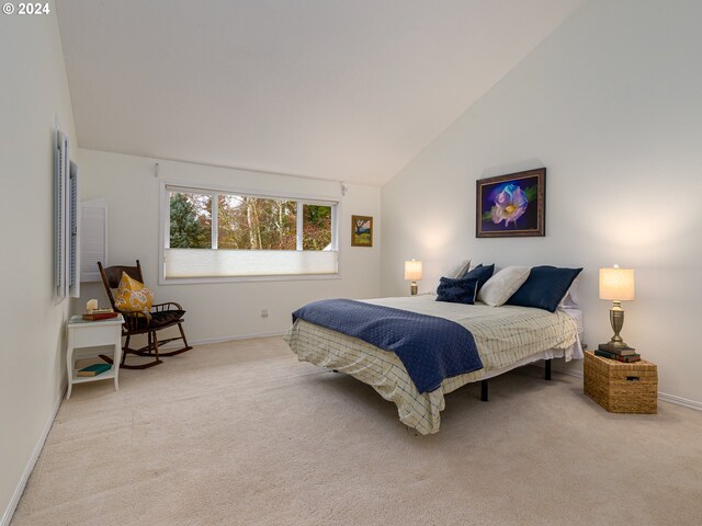 carpeted bedroom featuring high vaulted ceiling