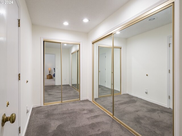 unfurnished bedroom featuring dark colored carpet