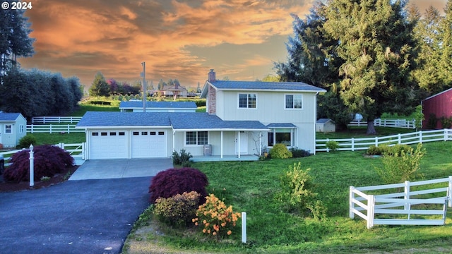 view of front of home featuring a garage and a yard