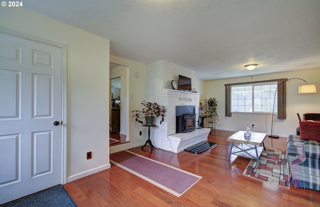 living area featuring baseboards and wood finished floors