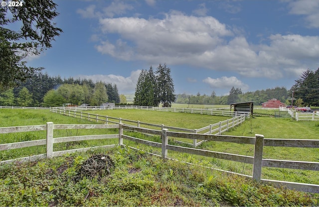 view of yard featuring an outbuilding and a rural view