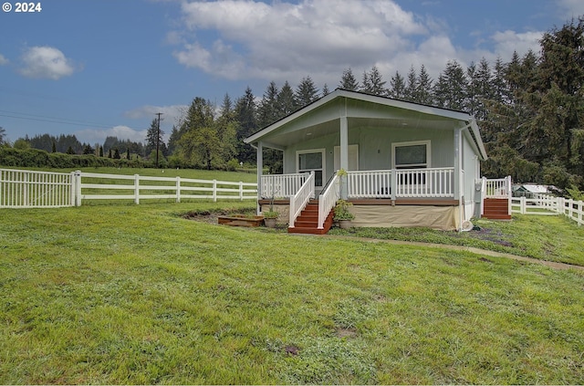 view of front of house featuring a porch, fence, and a front lawn