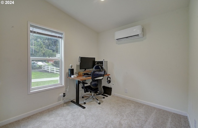 carpeted office with vaulted ceiling, plenty of natural light, baseboards, and a wall mounted AC