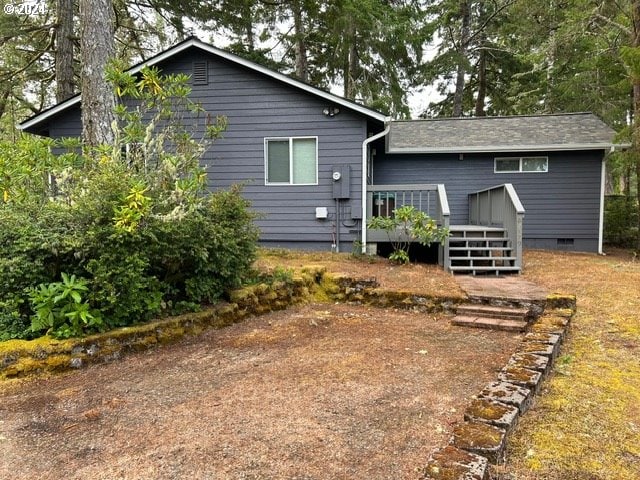 rear view of property with a wooden deck