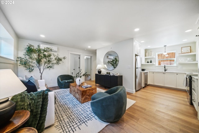 living room with light wood-type flooring and sink