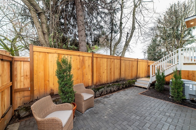 view of patio with a deck and central air condition unit