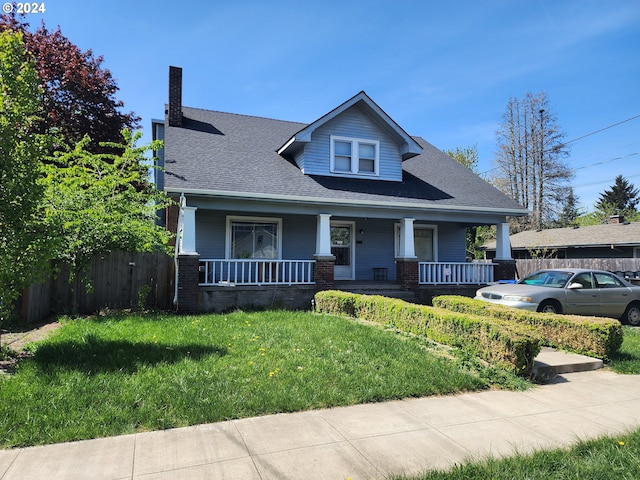 view of front of property with a front yard and a porch