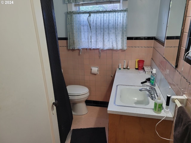 bathroom with backsplash, oversized vanity, tile walls, and toilet