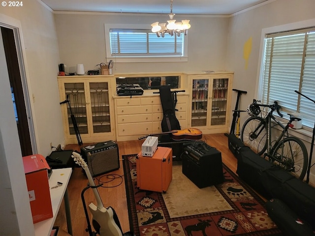 interior space with crown molding, hardwood / wood-style flooring, and a notable chandelier