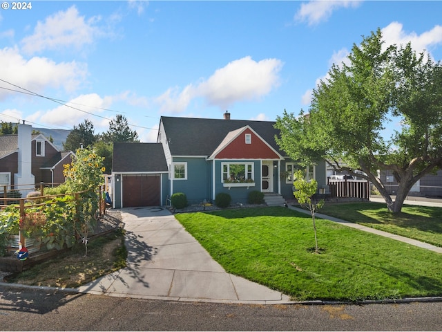 view of front of home with a front yard, concrete driveway, a chimney, and an attached garage