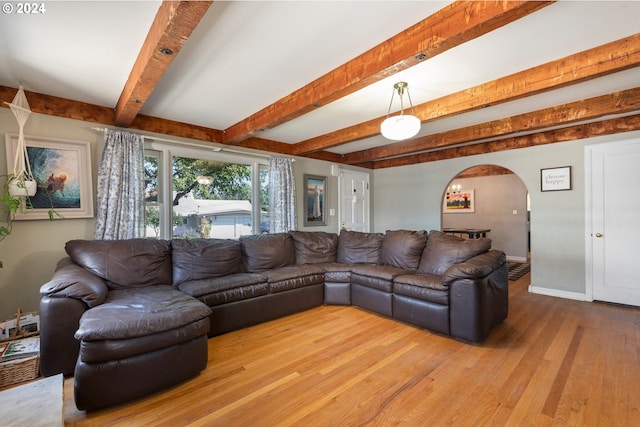 living room with hardwood / wood-style flooring and beam ceiling