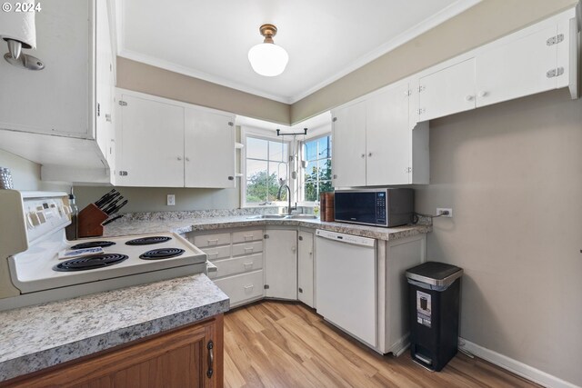 kitchen with white appliances, light hardwood / wood-style flooring, ornamental molding, sink, and white cabinets