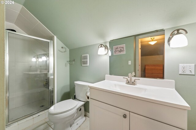 bathroom featuring vanity, toilet, a shower with shower door, and tile patterned floors