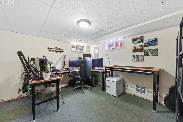 carpeted office with a drop ceiling