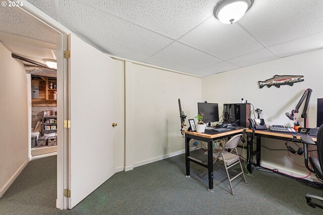 office space with a paneled ceiling and carpet