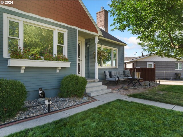 property entrance with a lawn