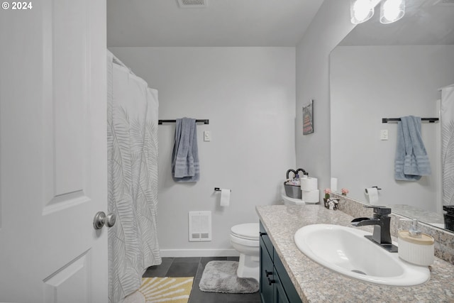 bathroom with vanity, toilet, and tile patterned flooring