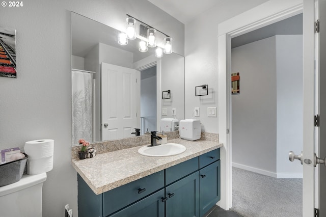 bathroom featuring vanity and toilet