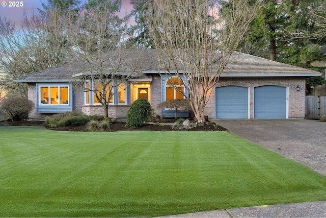 view of front of house featuring a yard and a garage