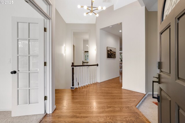 entryway featuring light wood-type flooring and an inviting chandelier