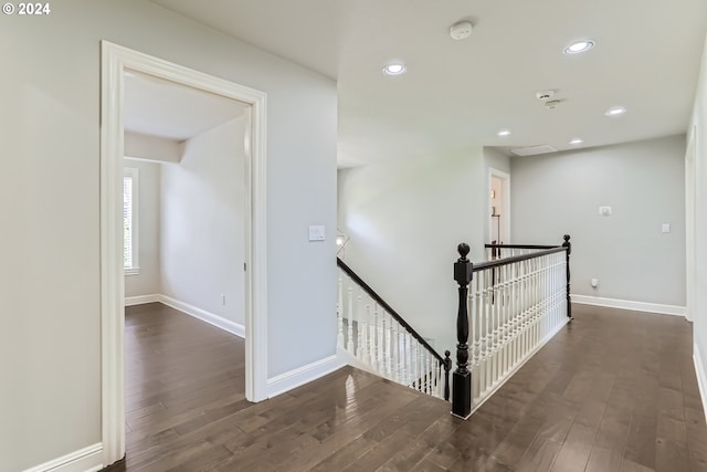 hallway with dark hardwood / wood-style flooring