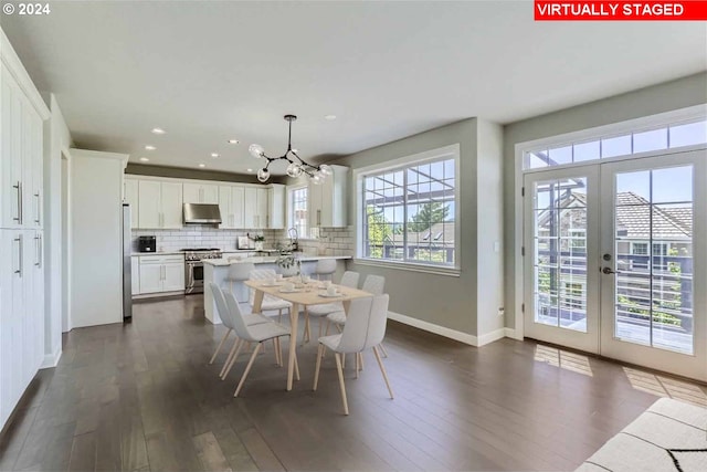 dining area with a notable chandelier, sink, a wealth of natural light, and french doors