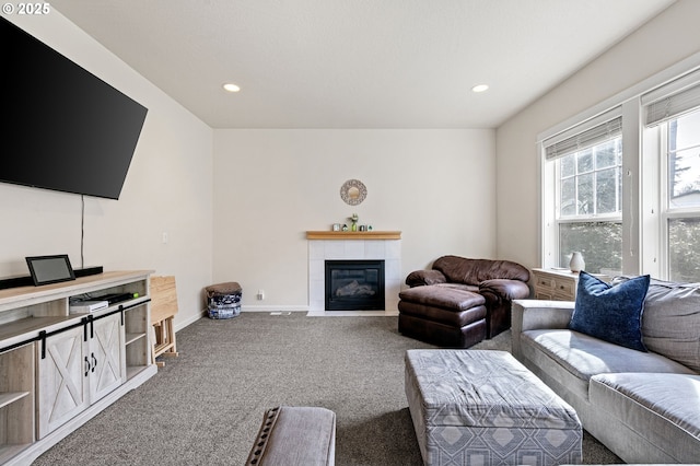 carpeted living area featuring recessed lighting, a fireplace, and baseboards