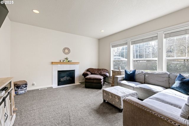 living area with carpet, a fireplace, baseboards, and recessed lighting