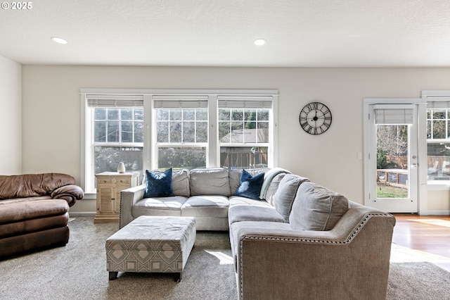 living room with recessed lighting, a textured ceiling, and wood finished floors