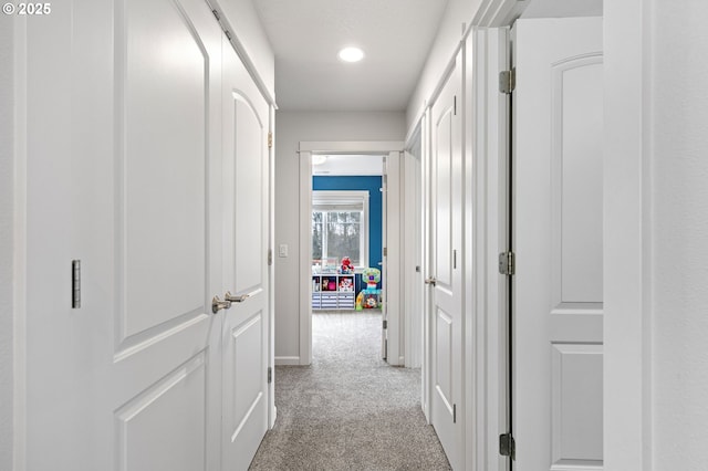 hall with recessed lighting and light colored carpet