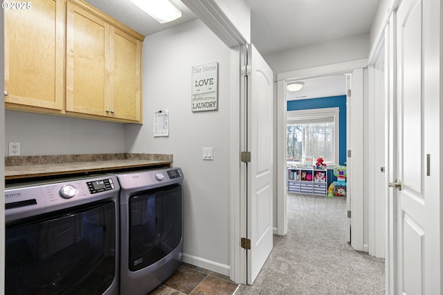 washroom featuring cabinet space, carpet, baseboards, and washing machine and clothes dryer