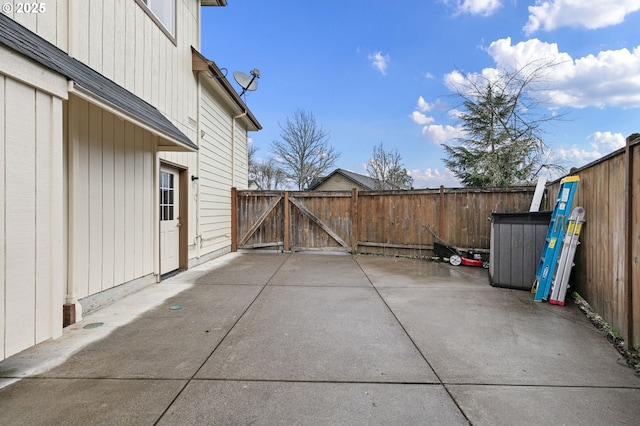 view of patio featuring fence and a gate