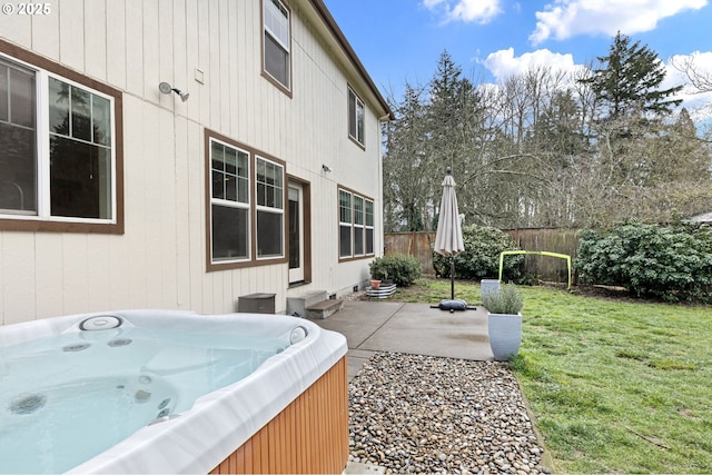 view of patio / terrace featuring a hot tub and fence