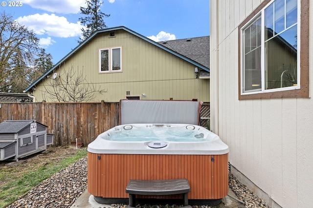 view of patio with fence and a hot tub