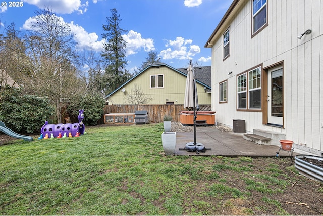 view of yard featuring entry steps, a patio, fence, and a hot tub