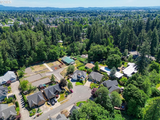 aerial view featuring a forest view and a residential view