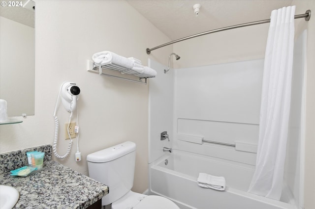 full bathroom with shower / tub combo with curtain, vanity, toilet, and a textured ceiling