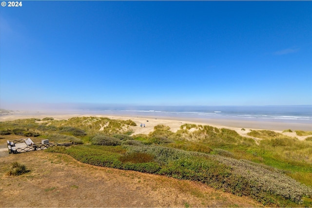 drone / aerial view featuring a water view and a beach view