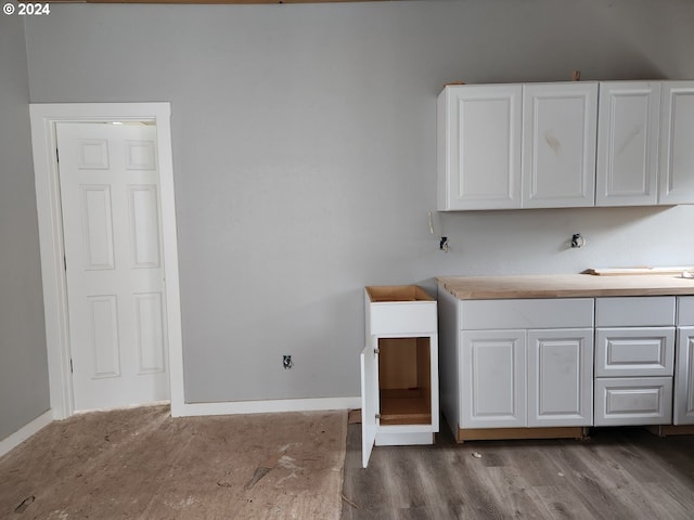 kitchen featuring white cabinets and dark wood-type flooring