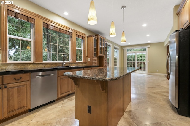 kitchen featuring decorative backsplash, appliances with stainless steel finishes, sink, and a healthy amount of sunlight