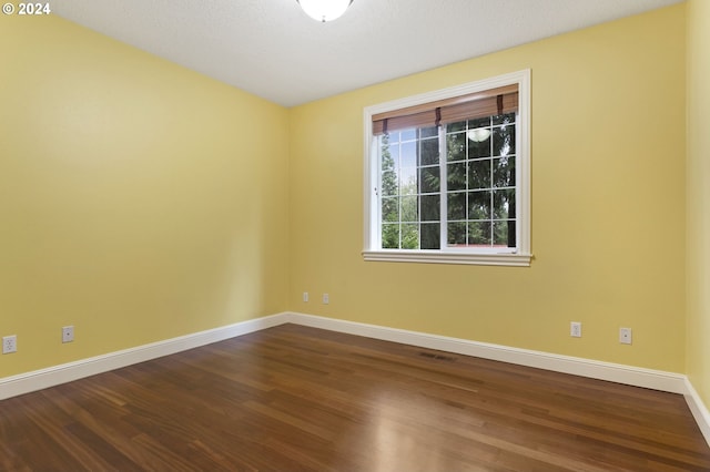 unfurnished room featuring hardwood / wood-style flooring and a textured ceiling