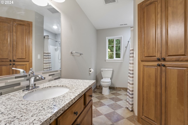 bathroom featuring curtained shower, vanity, toilet, and tasteful backsplash