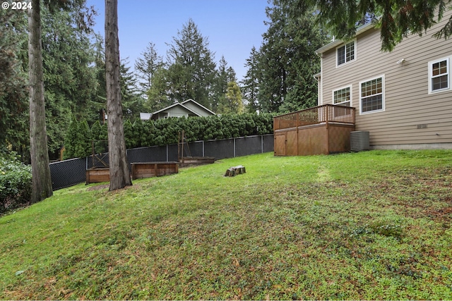 view of yard with central AC unit and a deck