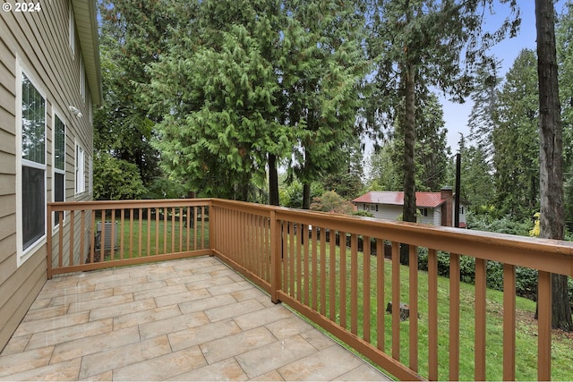 wooden deck with a lawn