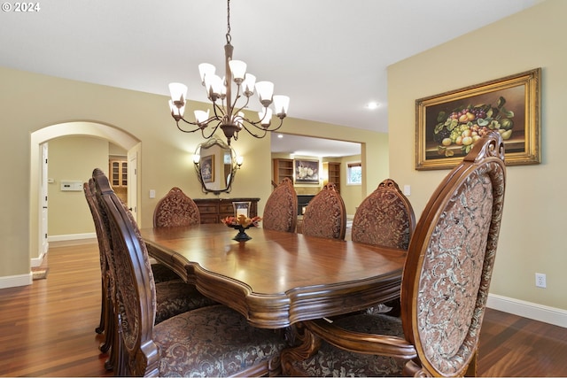 dining area featuring wood-type flooring and a chandelier