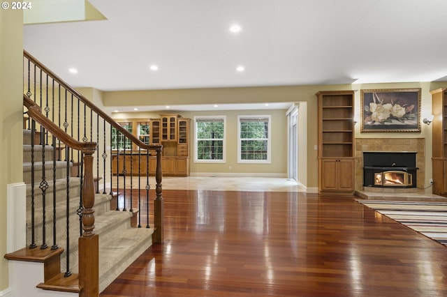 living room with hardwood / wood-style floors and a tile fireplace