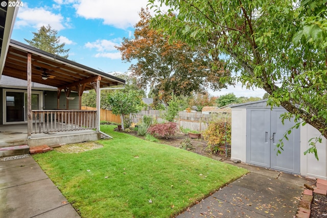 view of yard featuring a storage unit and ceiling fan