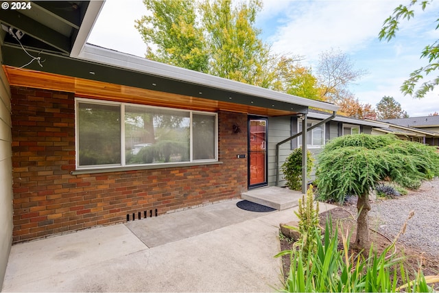 property entrance featuring a patio