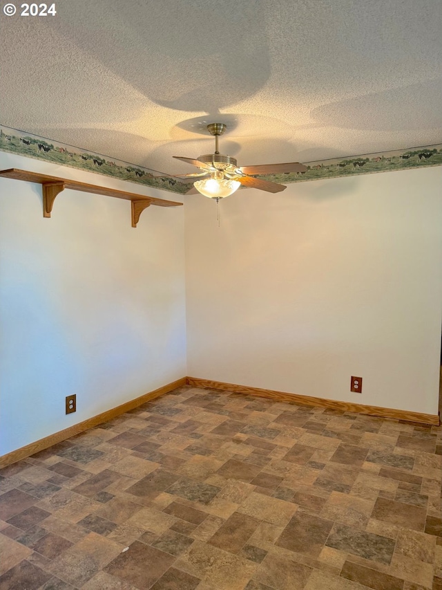 empty room featuring a textured ceiling and ceiling fan